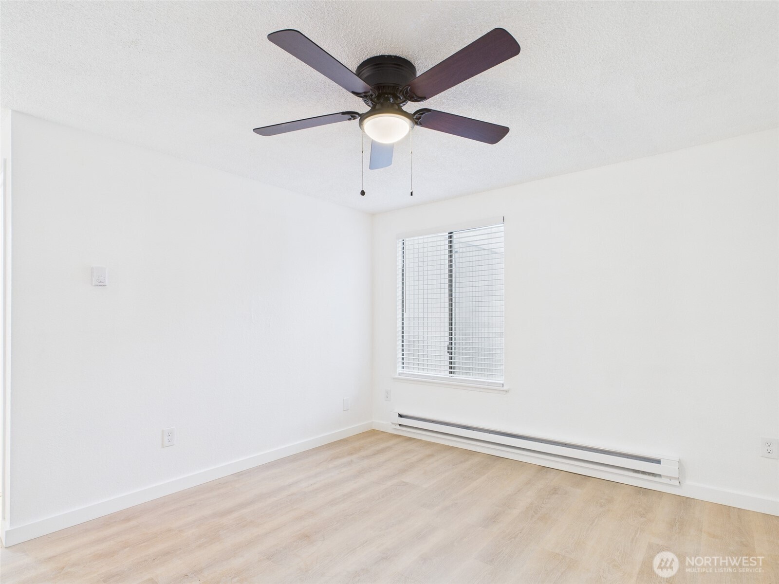 32142 46th Place Southwest, Unit M6 Federal Way, WA 98023 - Photo 18 of 29 an empty room with wooden floor and ceiling fan