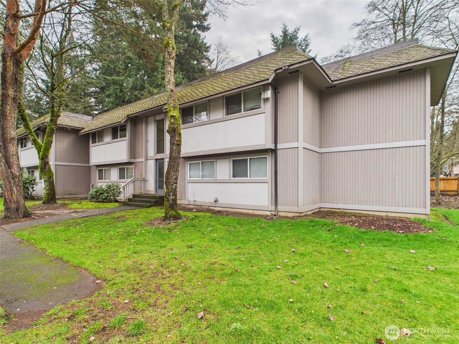 32142 46th Place Southwest, Unit M6 Federal Way, WA 98023 - Photo 25 of 29 a white house that has a small yard and a big yard