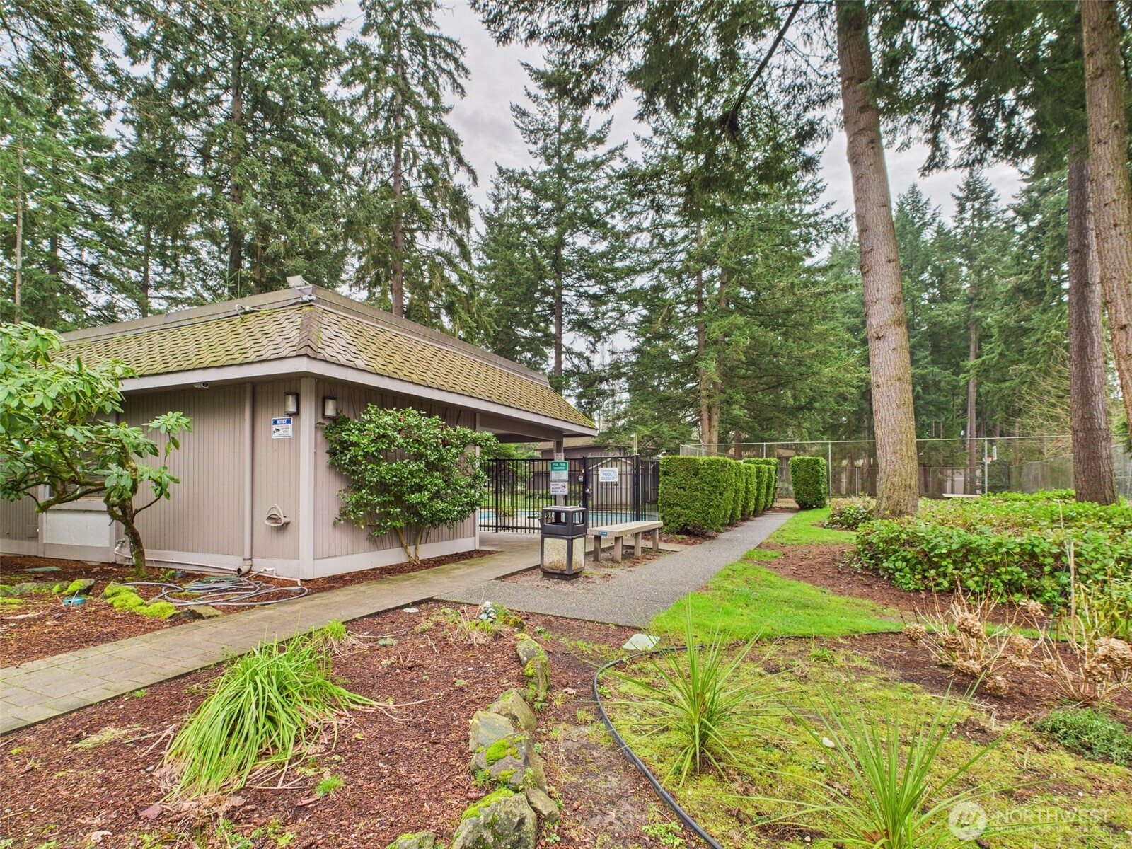 32142 46th Place Southwest, Unit M6 Federal Way, WA 98023 - Photo 26 of 29 a view of a patio with table and chairs under an umbrella