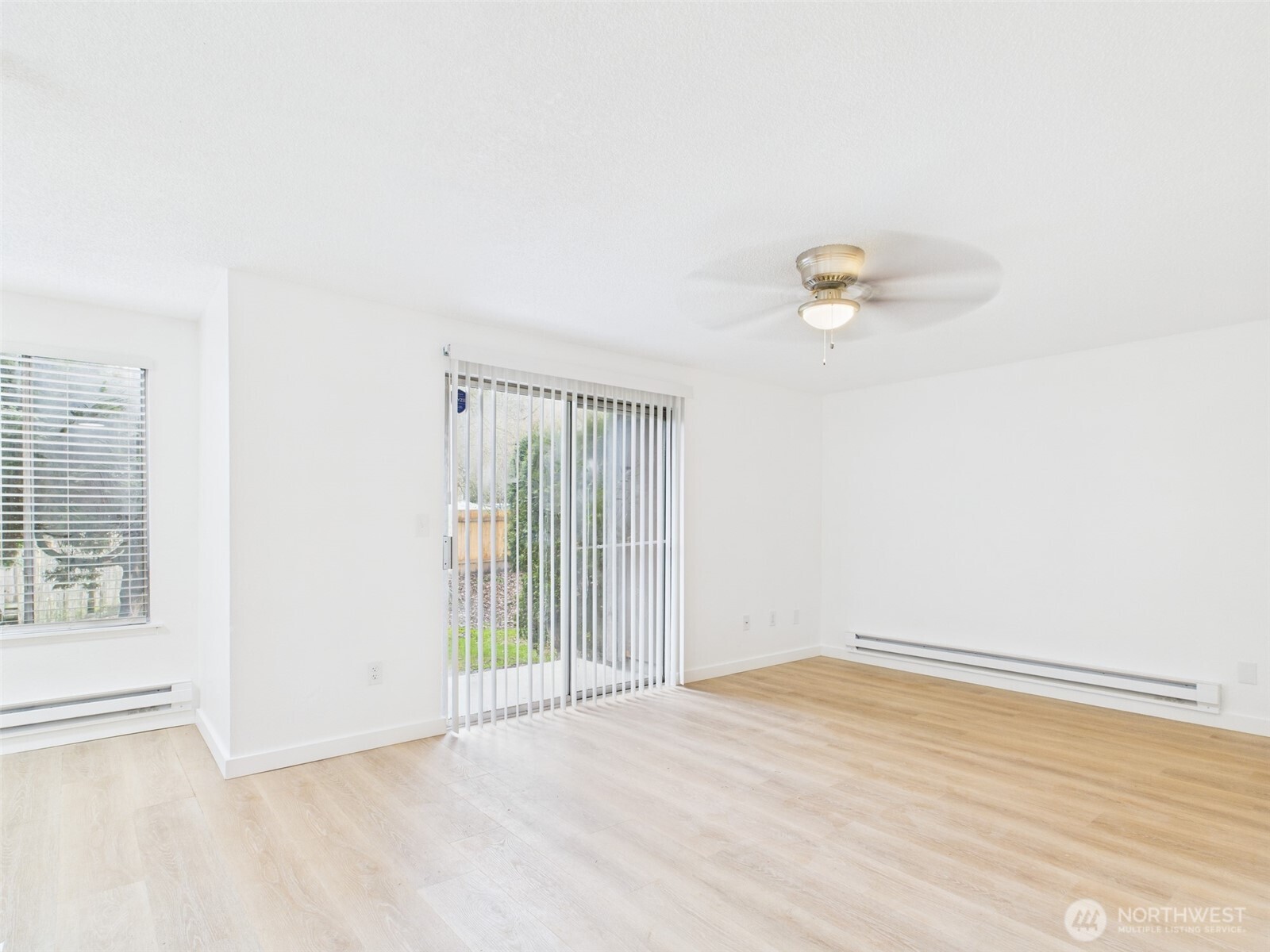 32142 46th Place Southwest, Unit M6 Federal Way, WA 98023 - Photo 3 of 29 an empty room with wooden floor and windows
