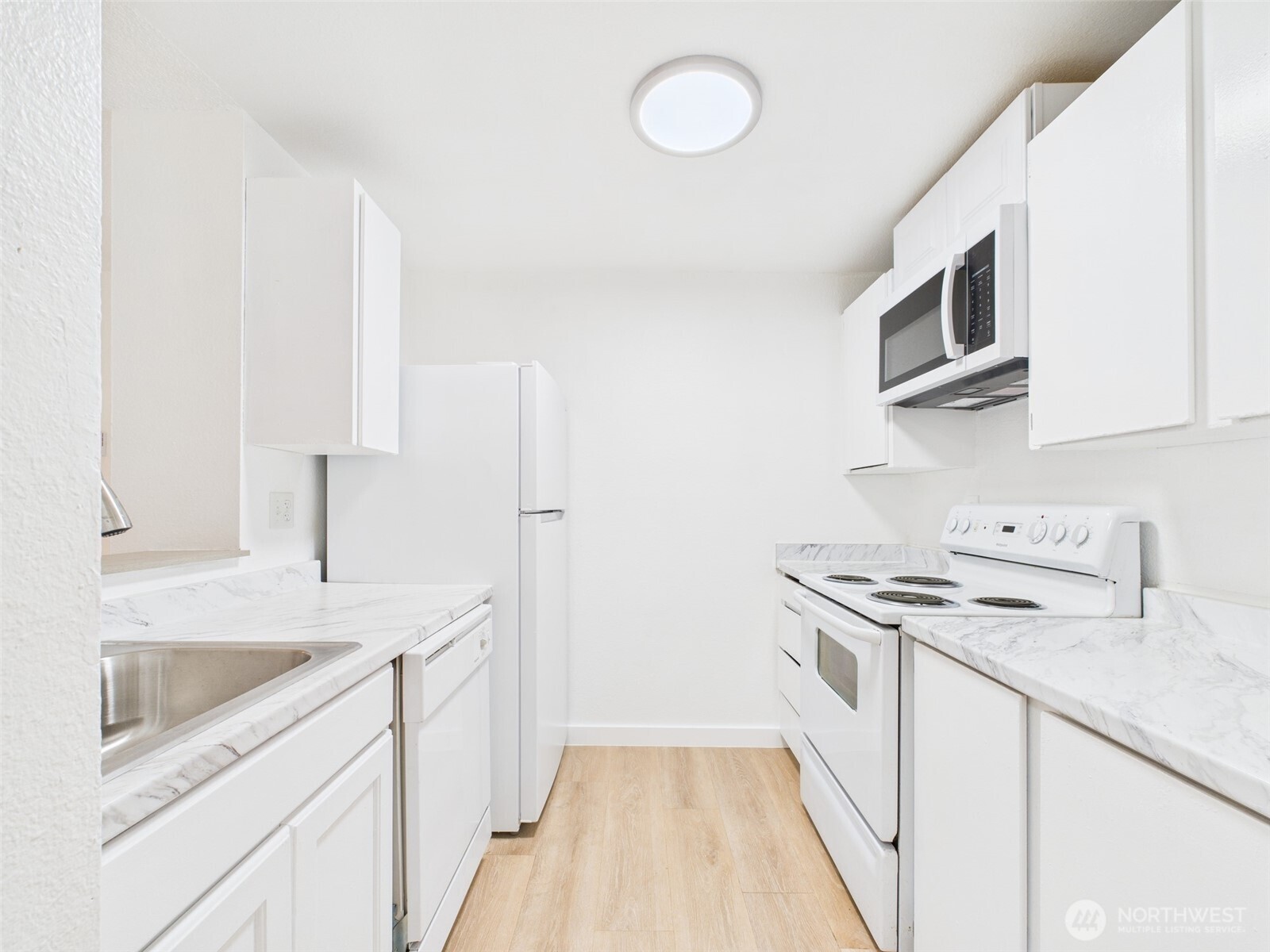 32142 46th Place Southwest, Unit M6 Federal Way, WA 98023 - Photo 7 of 29 a kitchen with stainless steel appliances granite countertop a sink stove and microwave