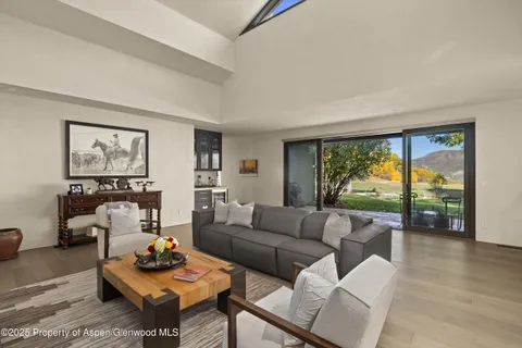 a view of patio with table and chairs under an umbrella