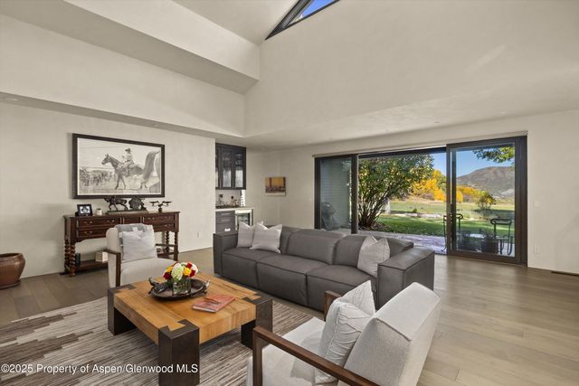 a view of patio with table and chairs under an umbrella