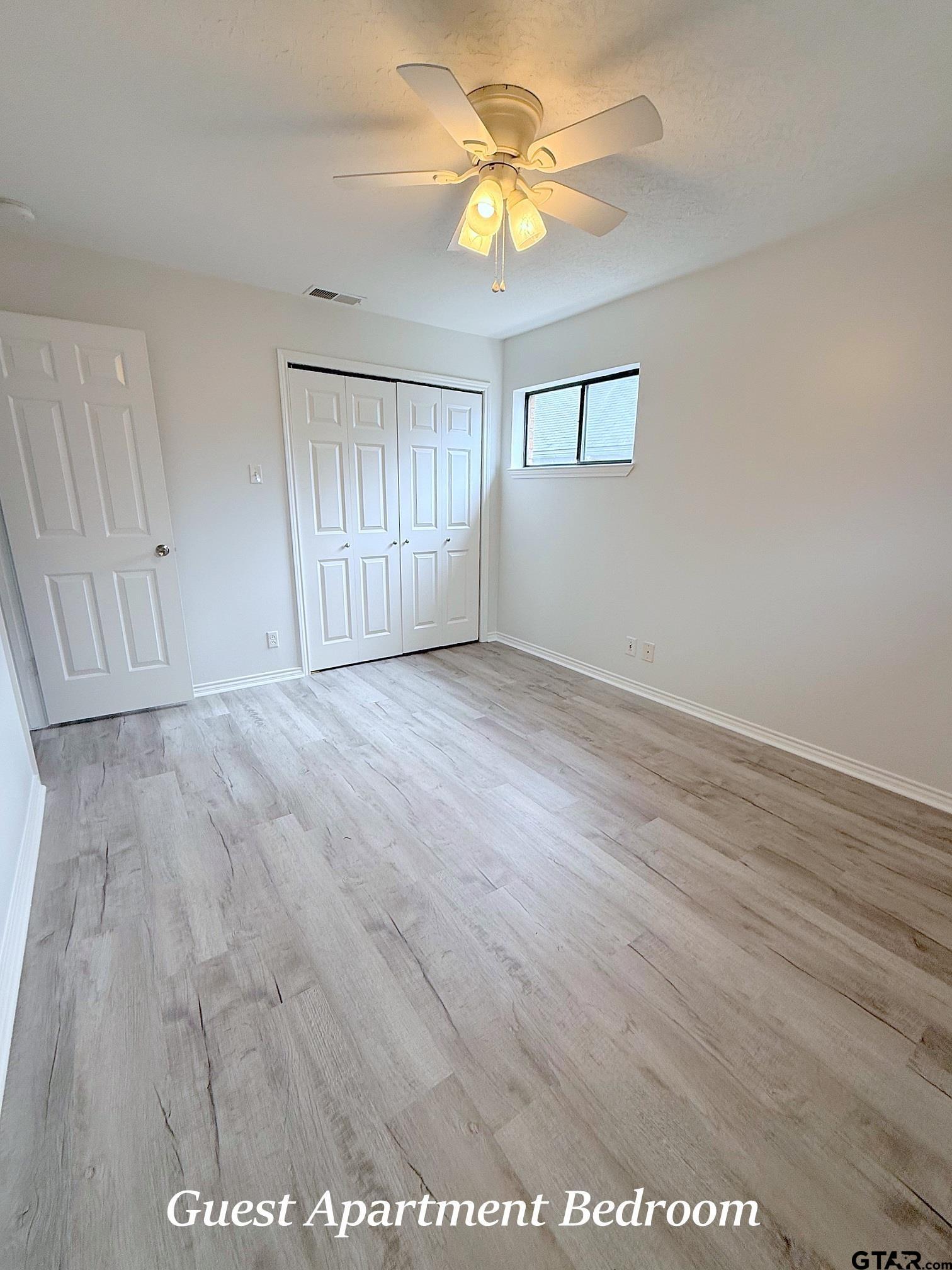 237 Oregon Street Van, TX 75790 - Photo 40 of 44 wooden floor in an empty room with a window