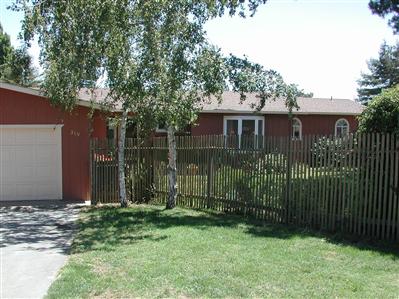 319 Mecham Road Petaluma, CA 94952 - Photo 2 of 12 a view of a house with a small yard and wooden fence