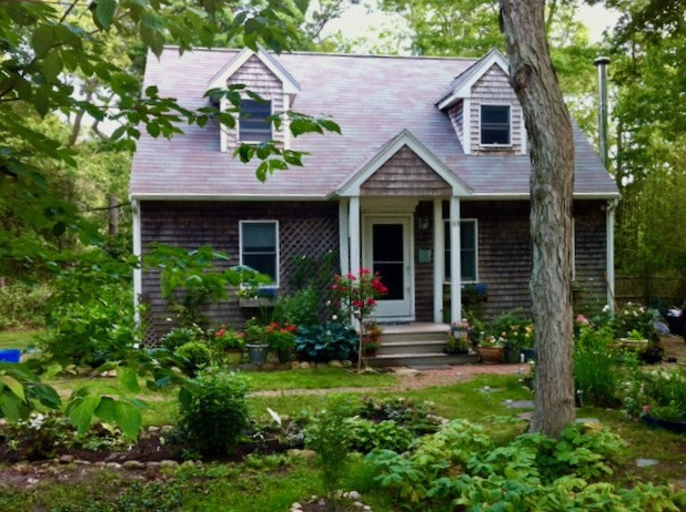 113 Leonard Circle Tisbury, MA 02568 - Photo 1 of 25 a front view of a house with garden
