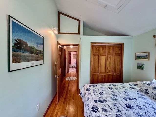 113 Leonard Circle Tisbury, MA 02568 - Photo 12 of 25 a bedroom with a bed and a chandelier
