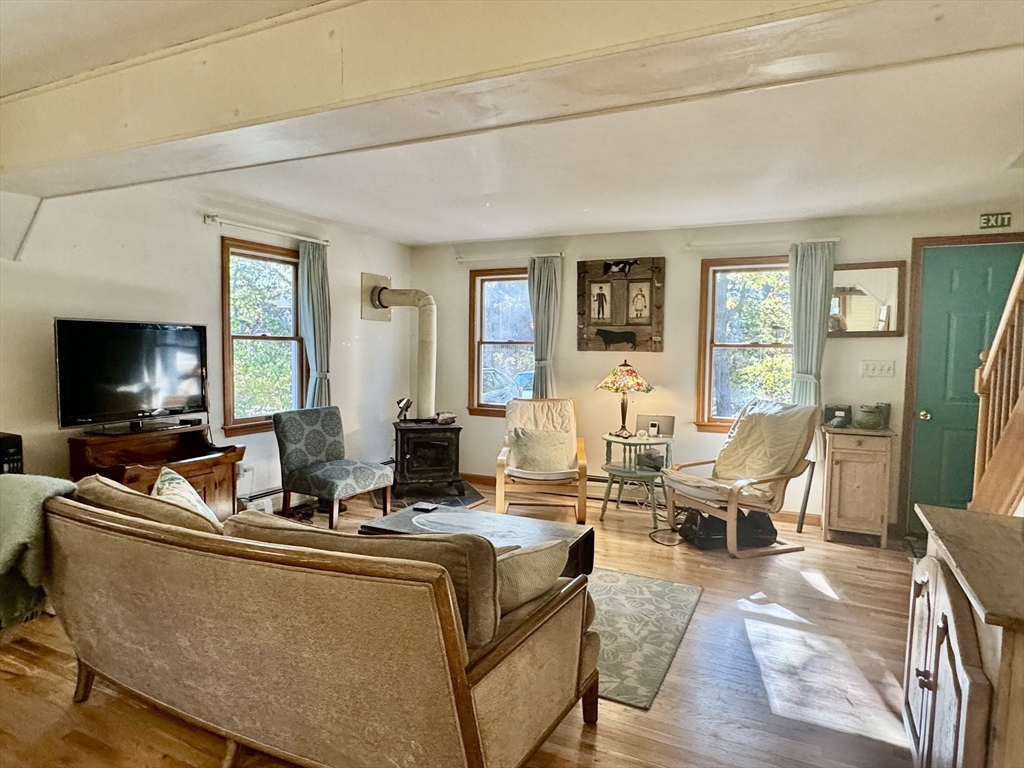 113 Leonard Circle Tisbury, MA 02568 - Photo 2 of 25 a living room with furniture and a flat screen tv
