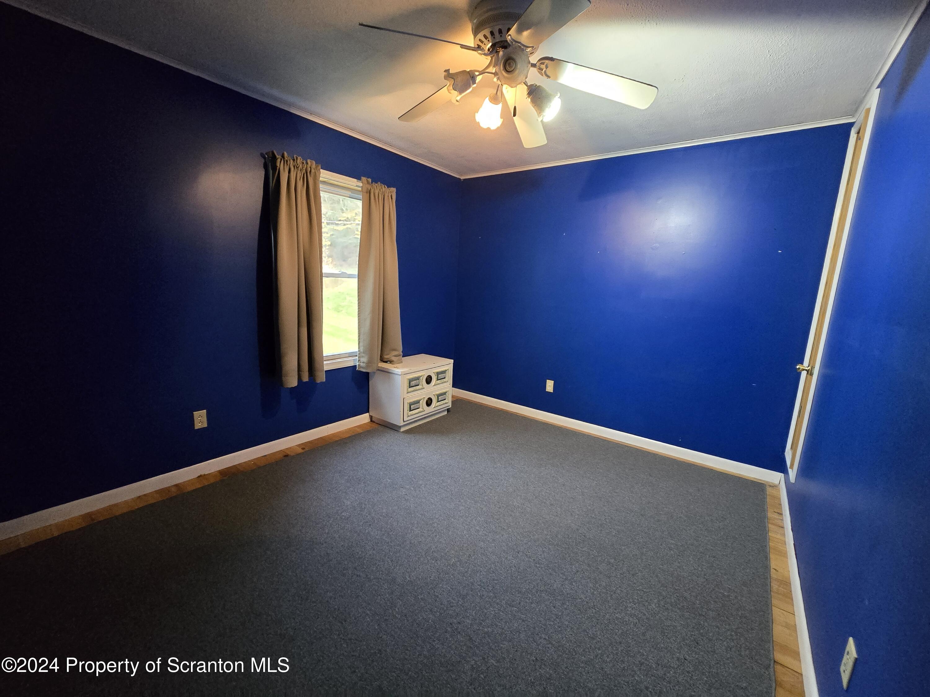 22 Barney Hollow Road Nicholson, PA 18446 - Photo 24 of 47 an empty room with windows and fan
