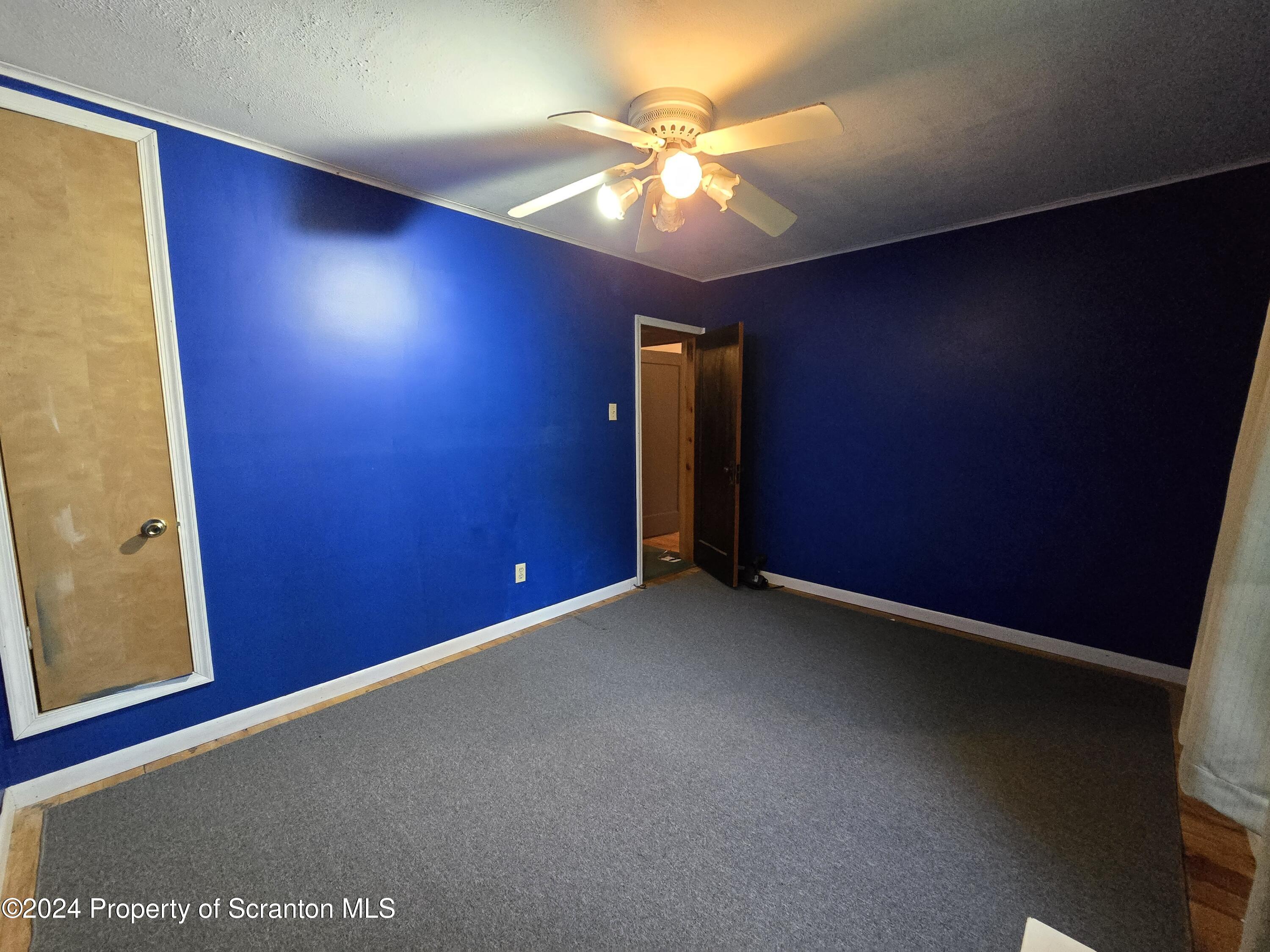 22 Barney Hollow Road Nicholson, PA 18446 - Photo 26 of 47 an empty room with a lamp and a ceiling fan