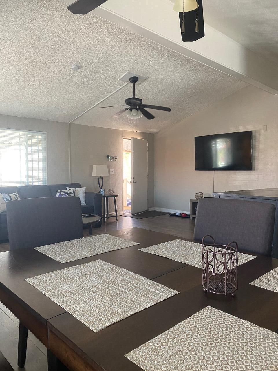 8300 Kern Canyon Road Bakersfield, CA 93306 - Photo 4 of 10 a living room with furniture and a flat screen tv