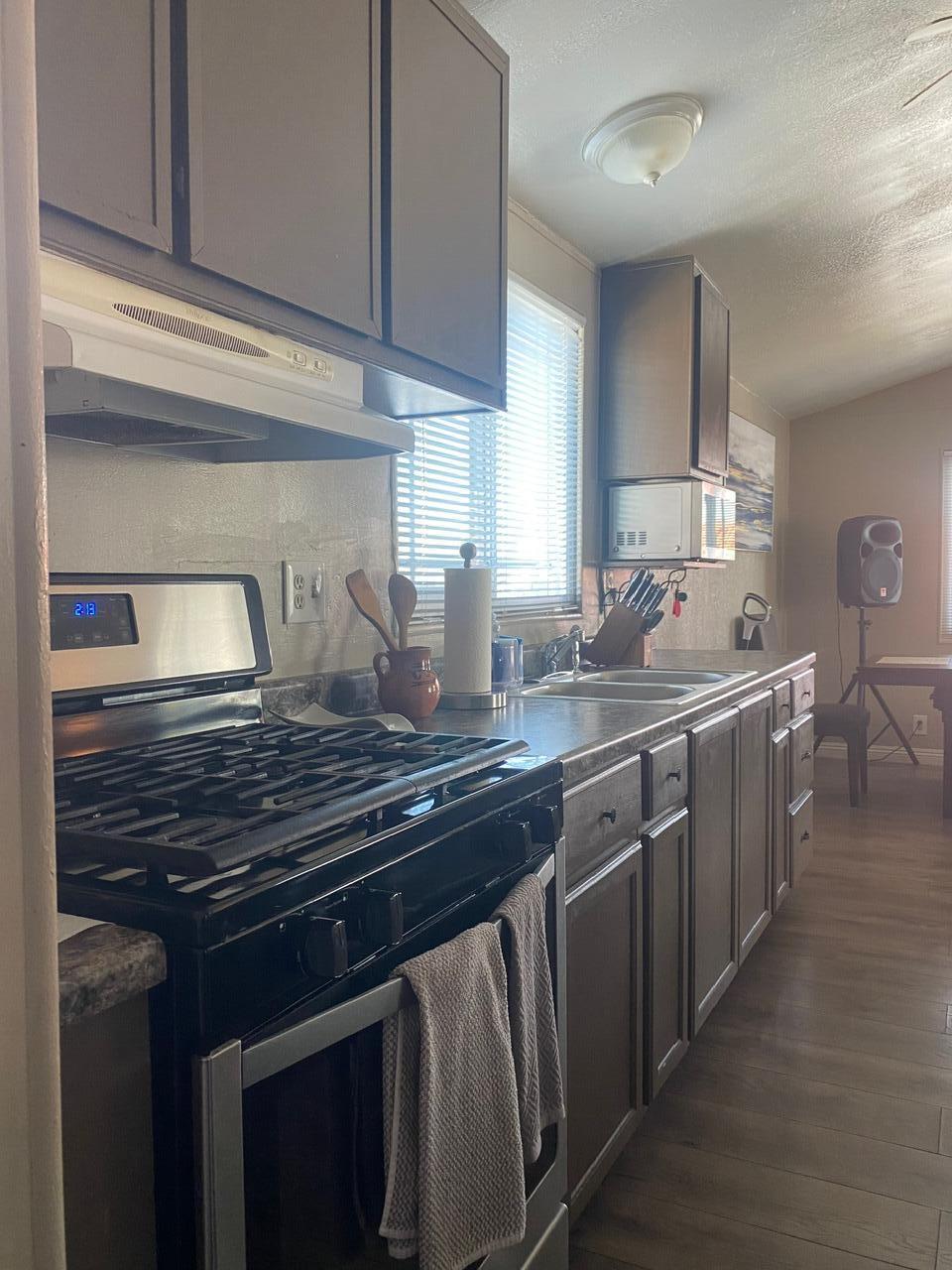 8300 Kern Canyon Road Bakersfield, CA 93306 - Photo 7 of 10 a kitchen with stainless steel appliances a sink stove and cabinets