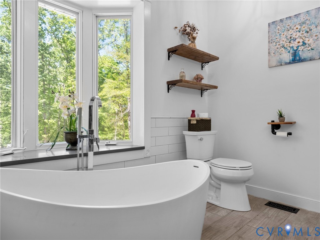 6126 Autumn Bluff Road Powhatan, VA 23139 - Photo 35 of 47 a bathroom with a sink a toilet and a window