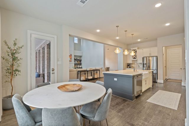 a large kitchen with a table and chairs