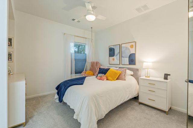 a bedroom with a bed and a dresser