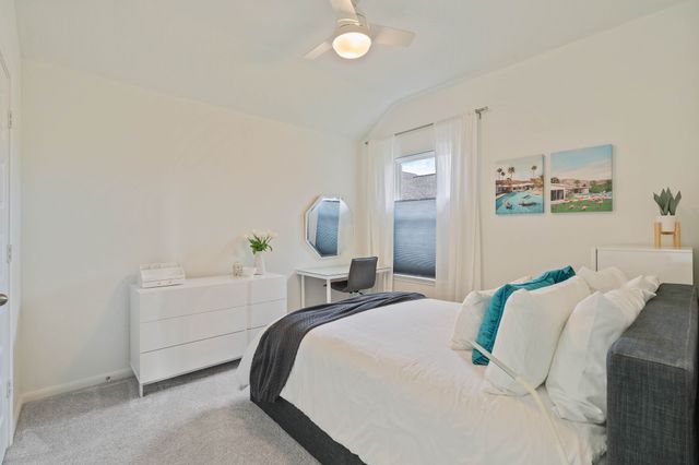 a bedroom with a bed and painting on the wall