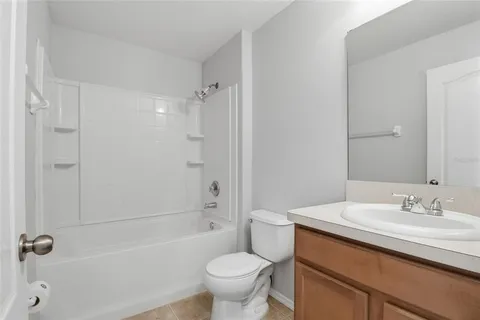 a bathroom with a sink toilet vanity and shower