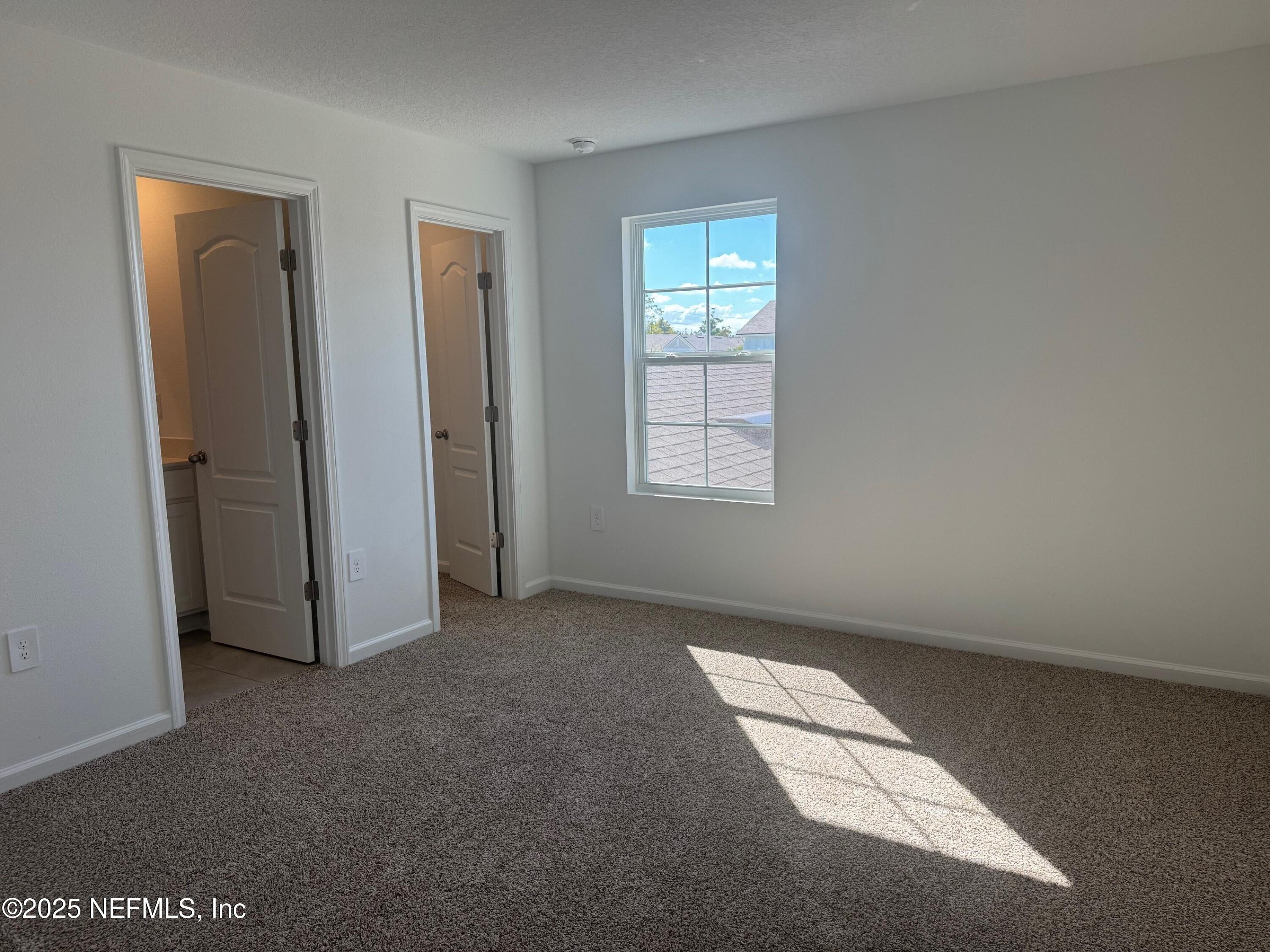 67 Blue Hvn Road St. Augustine, FL 32095 - Photo 21 of 58 an empty room with windows
