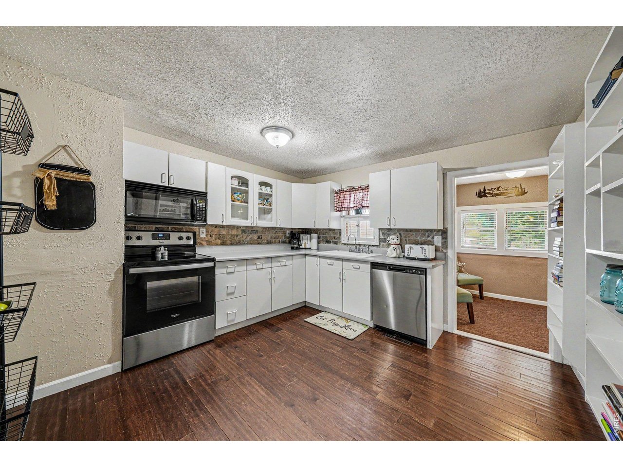 1430 30th Street Road Greeley, CO 80631 - Photo 8 of 22 a kitchen with a refrigerator and a stove top oven