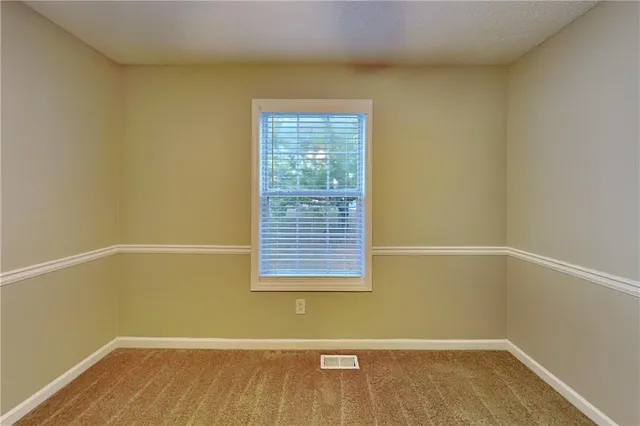 a view of a small space with wooden floor and a window