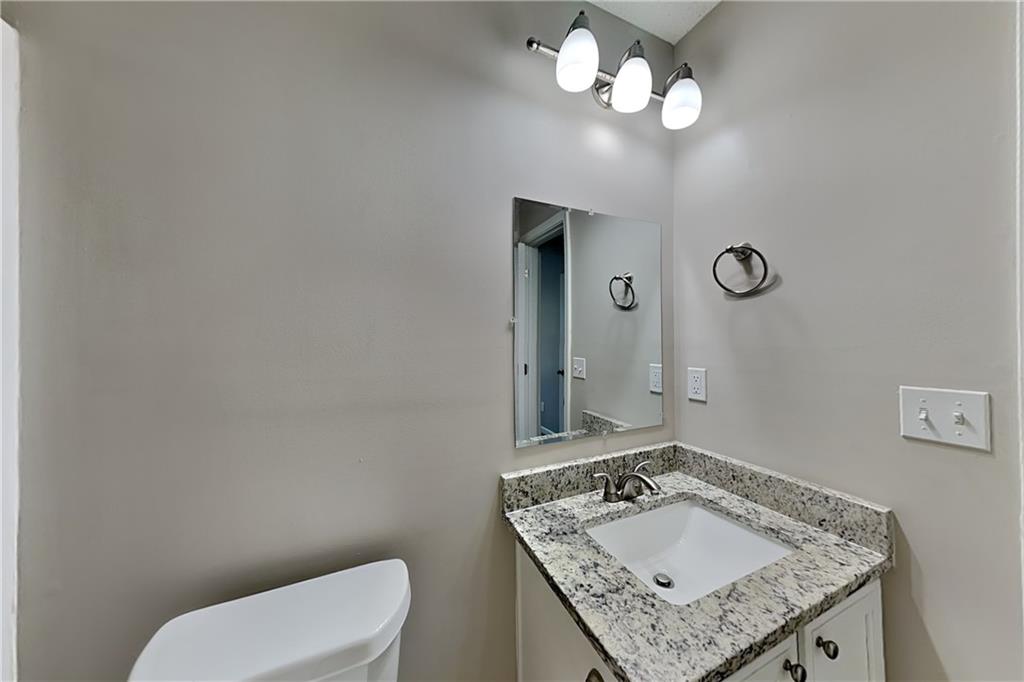 132 Hickory View Lane Acworth, GA 30101 - Photo 14 of 23 a bathroom with a granite countertop toilet sink and mirror