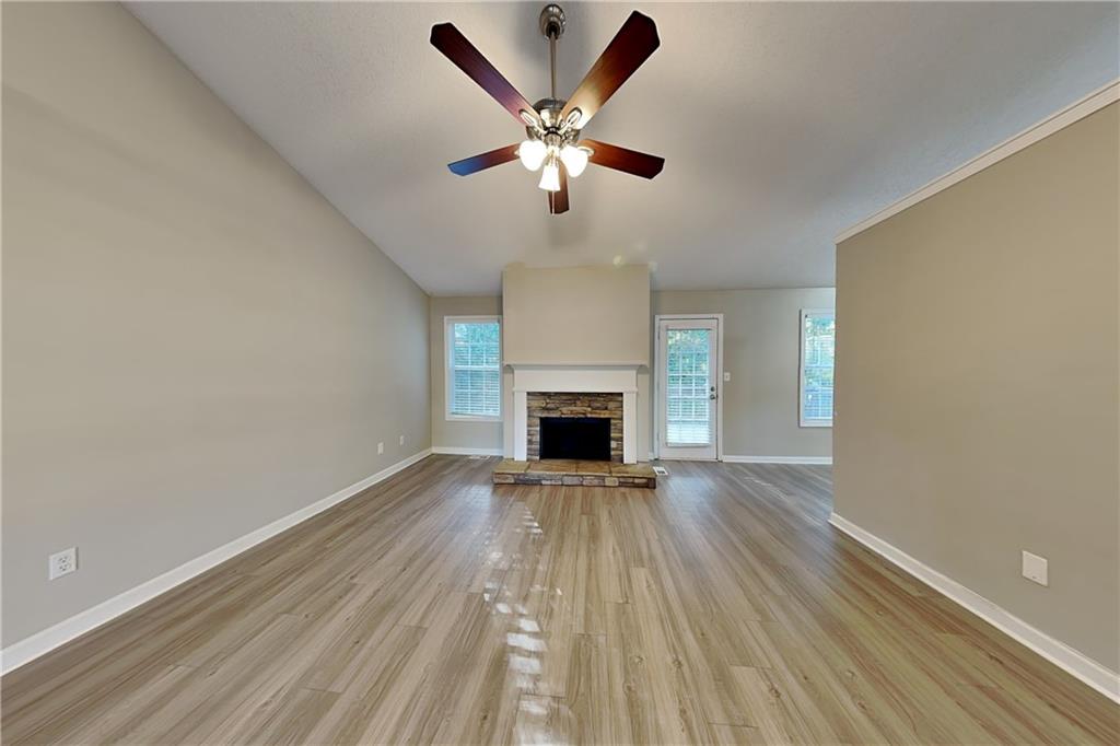 132 Hickory View Lane Acworth, GA 30101 - Photo 2 of 23 a view of an empty room with wooden floor and a fireplace