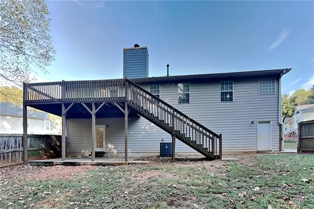 a view of a house with wooden deck