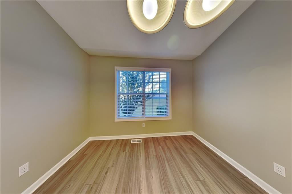 132 Hickory View Lane Acworth, GA 30101 - Photo 6 of 23 an empty room with wooden floor and windows