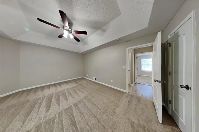 a view of a livingroom with a ceiling fan & hardwood floor
