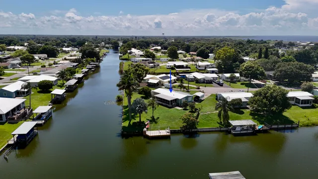 an aerial view of residential houses with lake view