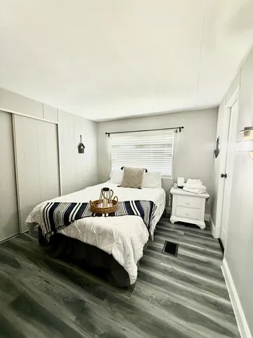 a view of a room with a window and hardwood floor