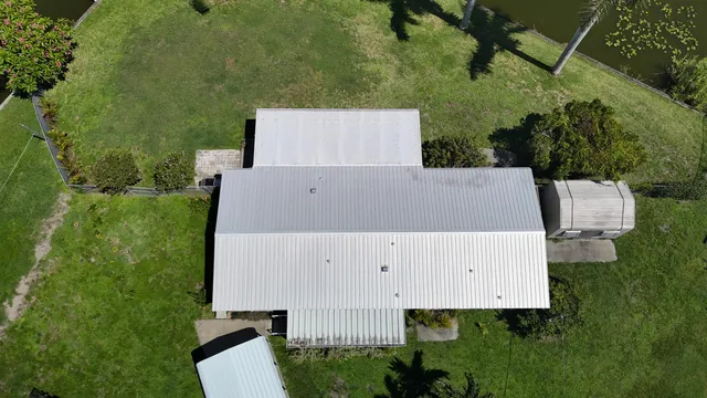 a living room with furniture a clock on wall and a table