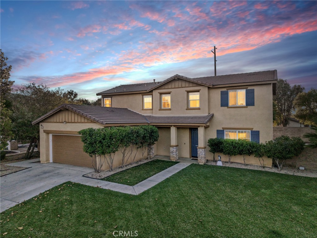 a front view of a house with a garden and plants