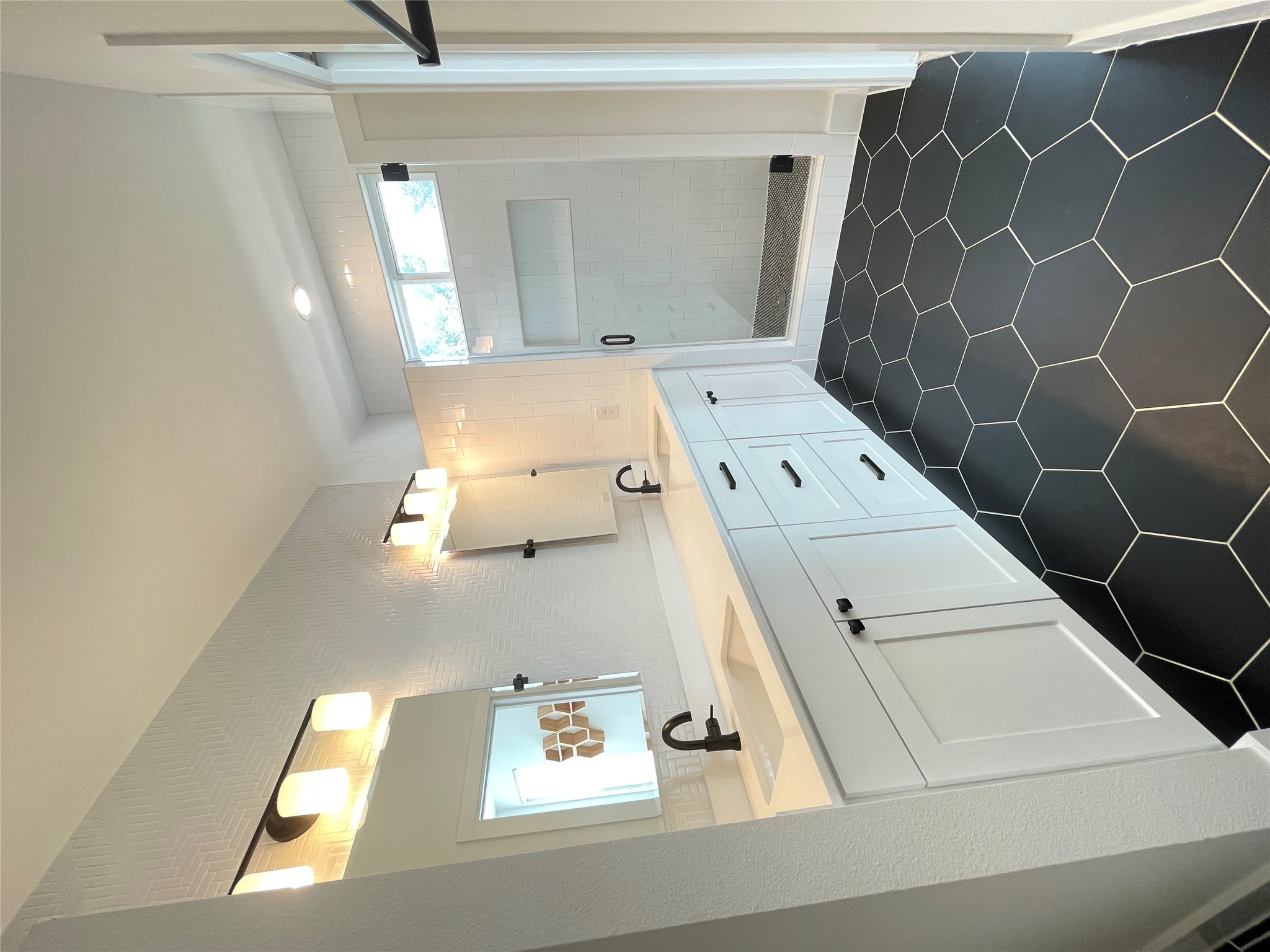 1106 Walton Lane, Unit B Austin, TX 78721 - Photo 15 of 28 Full bath with double vanity, a shower stall, and dark tile patterned floors