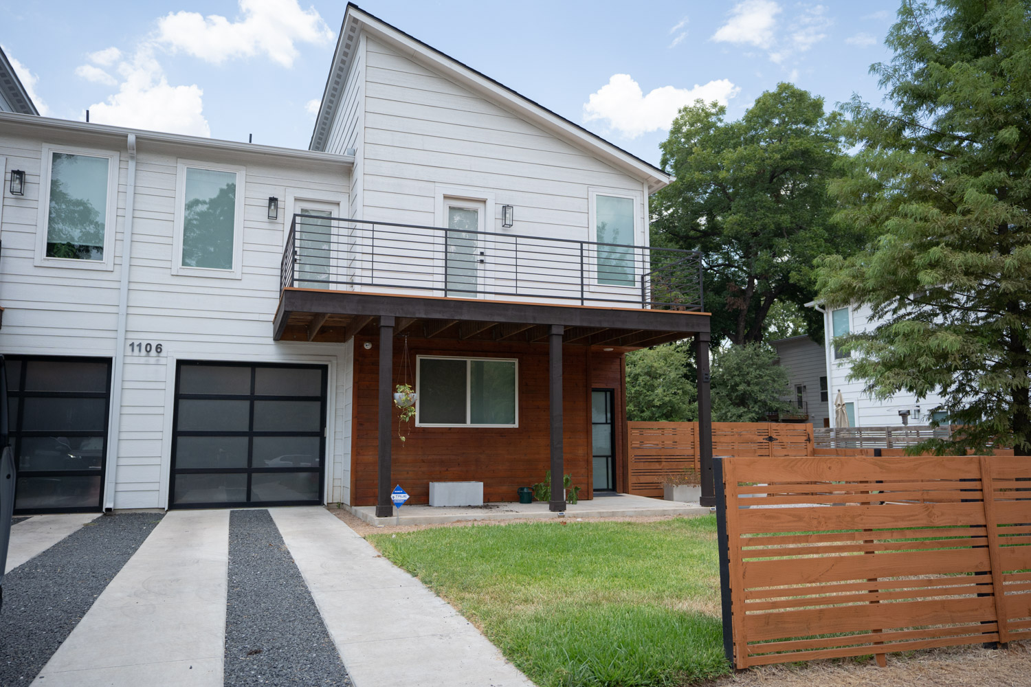 1106 Walton Lane, Unit B Austin, TX 78721 - Photo 2 of 28 Contemporary house featuring a balcony, a garage, and driveway