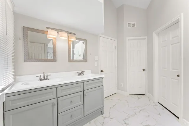 a bathroom with a double vanity sink and mirror
