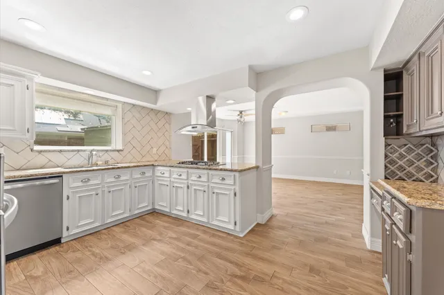 a kitchen with granite countertop a sink and cabinets