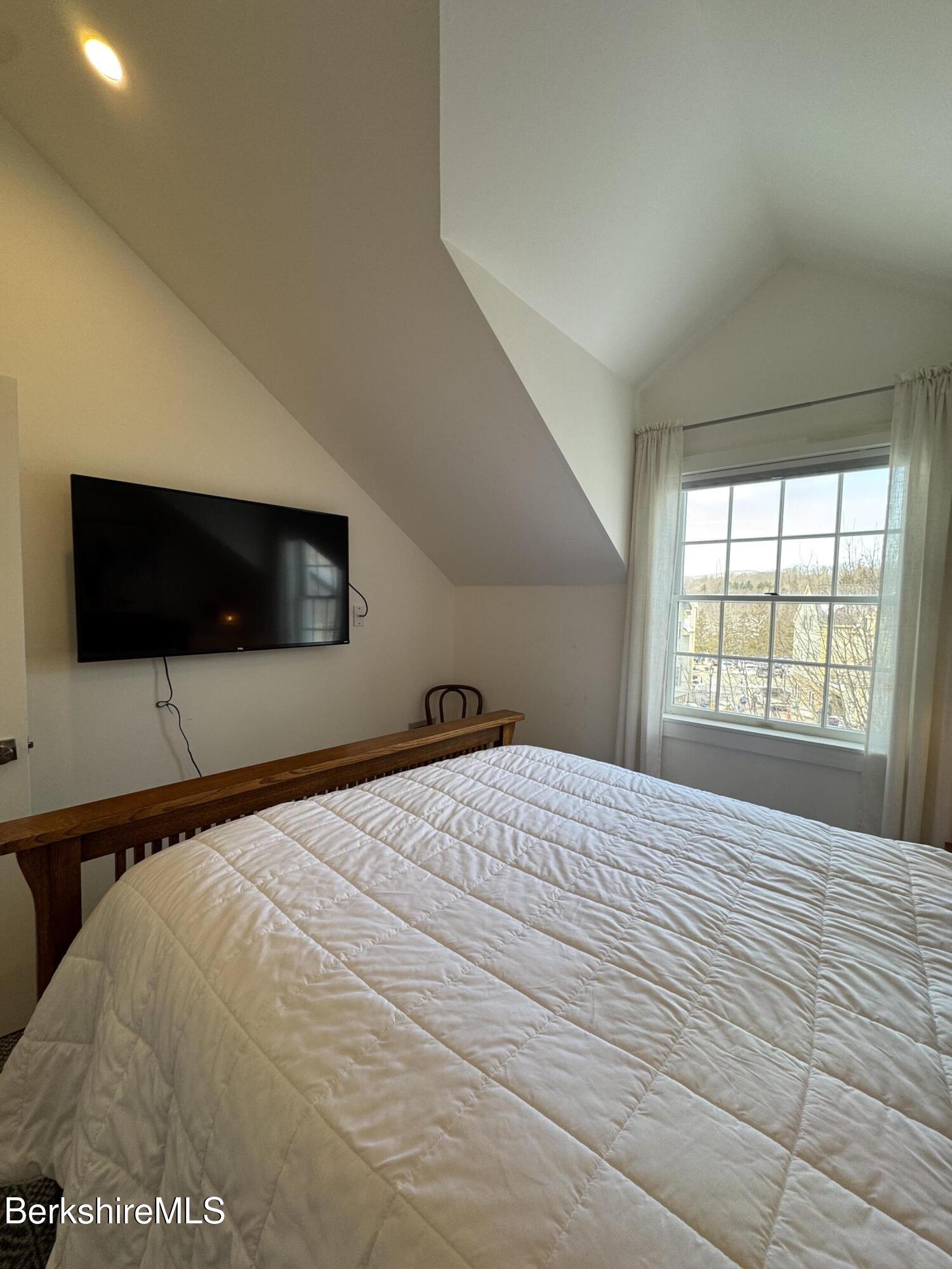 803 Crane Hancock, MA 01237 - Photo 15 of 24 a bedroom with a bed and a flat screen tv