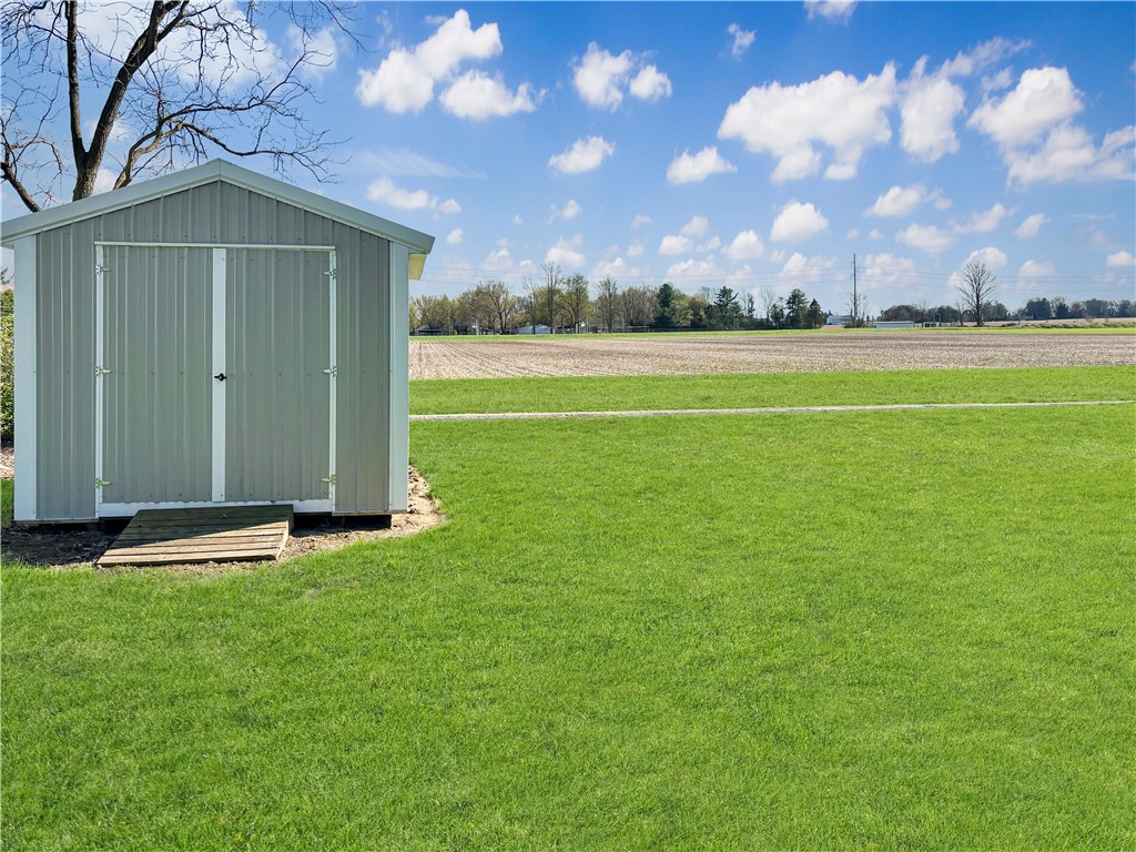 8411 Pitsburg-Laura Road Arcanum, OH 45304 - Photo 14 of 16 This serene landscape features a metal storage shed amidst expansive green fields.