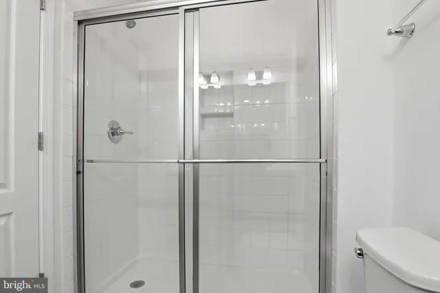 a bathroom with a glass shower door