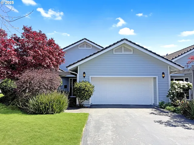a front view of house with yard and green space