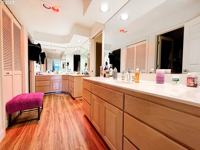 a large kitchen with sink and dishwasher with wooden floor