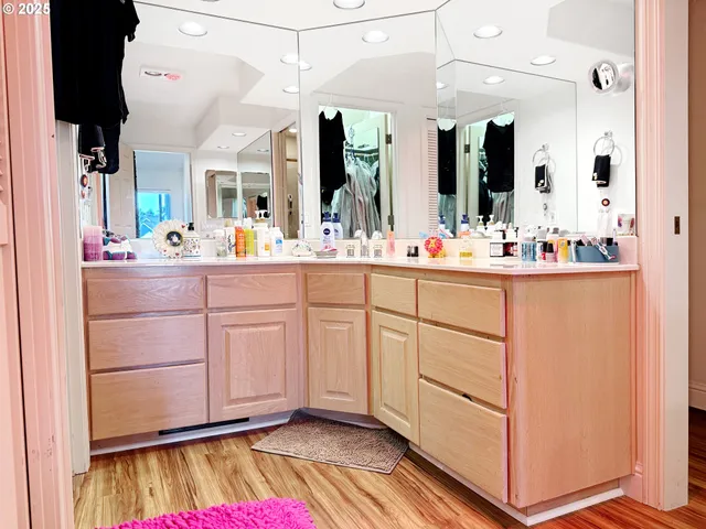 a room with mirror and cabinets
