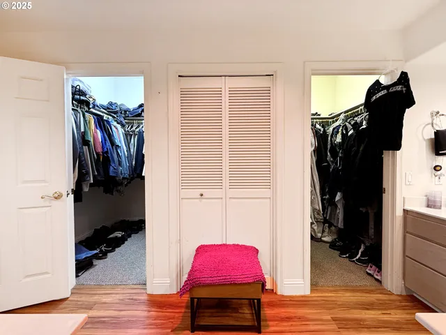 a view of walk in closet with clothes and shoes