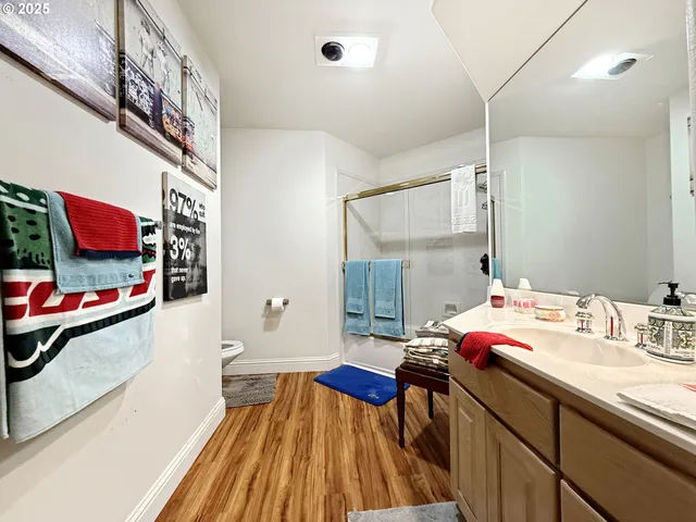 a bathroom with a sink mirror and a shower