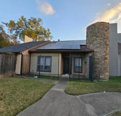 a front view of a house with a garden