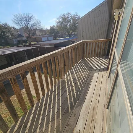 a view of balcony with wooden floor