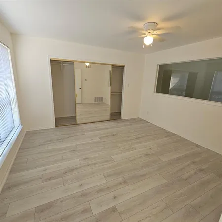 a view of an empty room with glass door