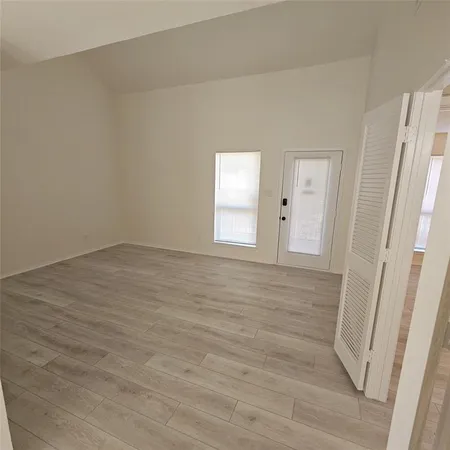 a view of an empty room and wooden floor