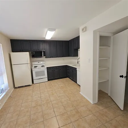 a kitchen with stainless steel appliances a refrigerator and a stove top oven